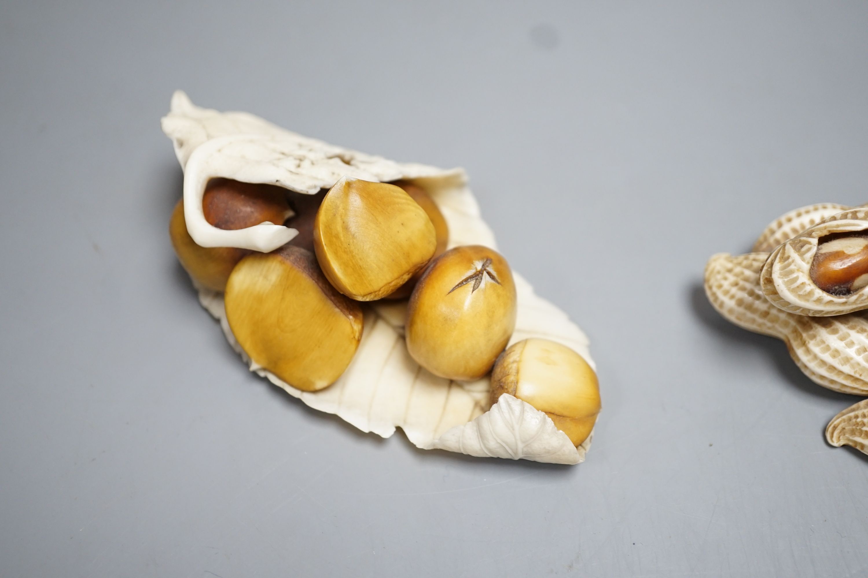 Two Japanese Ivory models of group groups of nuts, first half 20th century, largest 11cm